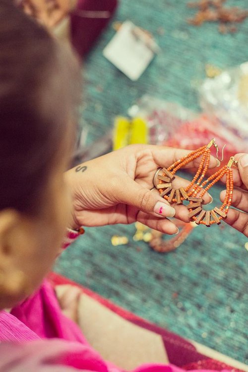 artisan making earrings at Daughters of the Ganges in India