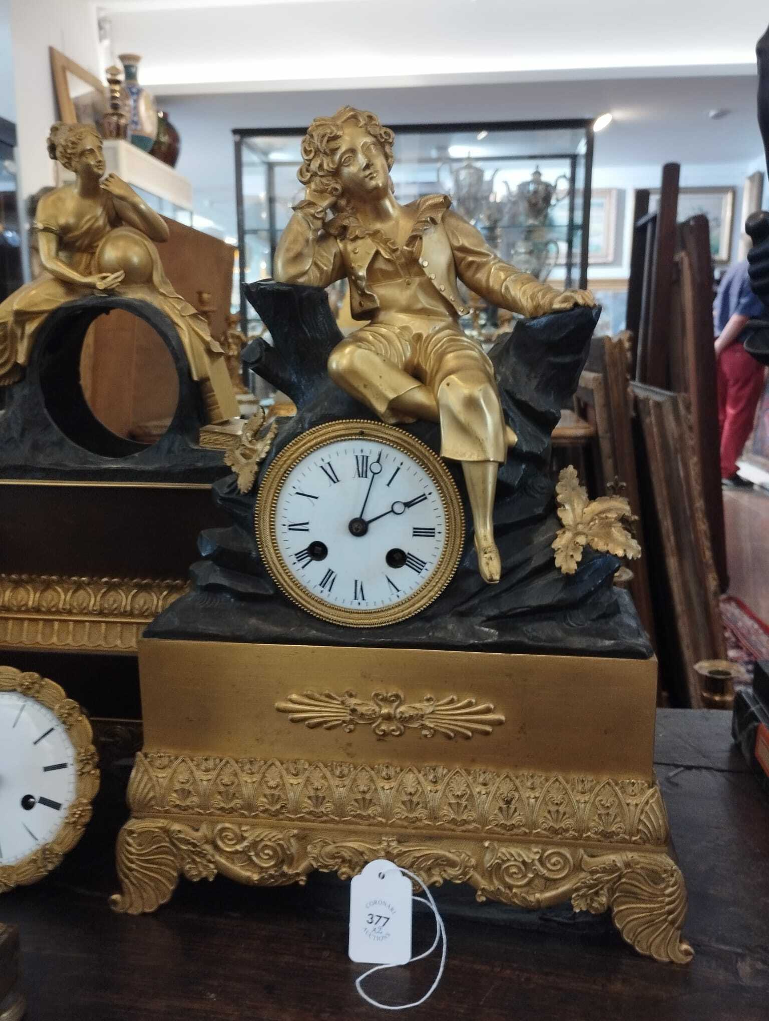 Two French gilt and patinated bronze mantel clocks crowned with ...