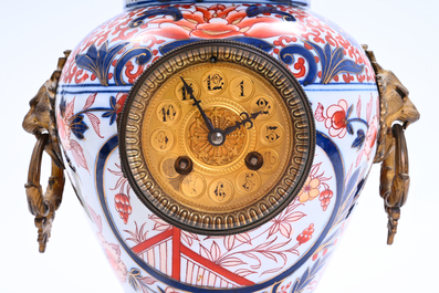 A Japanese gilt bronze mounted three-piece Imari porcelain clock garniture with floral design, Meiji, 19th C.