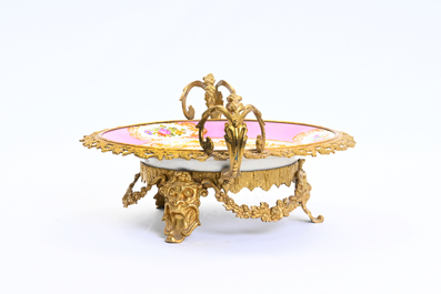 A gilt bronze mounted Sevres style 'romantic subject' dish with pink ground, marked France, 20th C.