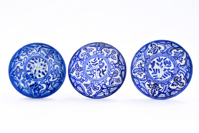 Fourteen blue and white Islamic pottery bowls and plates with floral design, Persia and/or North Africa, 19th C.