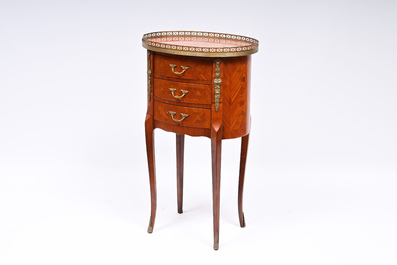 An oval French gilt bronze mounted marquetry side table with three drawers, 20th C.