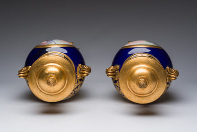 Paire de vases couvertes &agrave; fond bleu royale &agrave; la mani&egrave;re de S&egrave;vres aux montures dor&eacute;es et &agrave; d&eacute;cor de sc&egrave;ne d'amour, France, 20&egrave;me si&egrave;cle