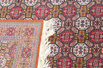 Deux tapis orientaux de type Qom (Qum/Ghom) &agrave; d&eacute;cor floral et d'animaux parmi des branches fleuries, laine sur coton, 20&egrave;me si&egrave;cle
