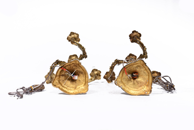 A pair of French Louis XV style gilt bronze four-light candlesticks with floral relief design, 19th/20th C.