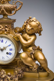 Garniture de chemin&eacute;e en trois pi&egrave;ces en bronze dor&eacute; &agrave; d&eacute;cor floral et de putti, France, 19&egrave;me/20&egrave;me si&egrave;cle