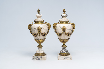 A pair of Neoclassical marble cassolettes mounted with rams' heads and floral garlands, 19th/20th C.