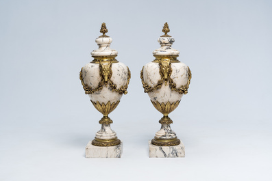 A pair of Neoclassical marble cassolettes mounted with rams' heads and floral garlands, 19th/20th C.