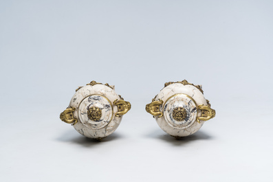 A pair of Neoclassical marble cassolettes mounted with rams' heads and floral garlands, 19th/20th C.