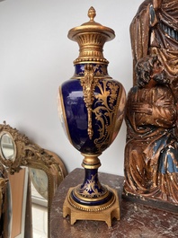 Paire de vases couvertes &agrave; fond bleu royale &agrave; la mani&egrave;re de S&egrave;vres aux montures dor&eacute;es et &agrave; d&eacute;cor de sc&egrave;ne d'amour, France, 20&egrave;me si&egrave;cle