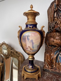 Paire de vases couvertes &agrave; fond bleu royale &agrave; la mani&egrave;re de S&egrave;vres aux montures dor&eacute;es et &agrave; d&eacute;cor de sc&egrave;ne d'amour, France, 20&egrave;me si&egrave;cle