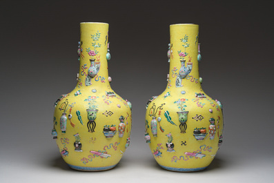An exceptional pair of Chinese famille rose yellow sgraffito-ground bottle vases with applied design of antiquities, 19th C.
