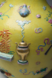 An exceptional pair of Chinese famille rose yellow sgraffito-ground bottle vases with applied design of antiquities, 19th C.