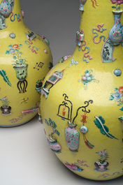 An exceptional pair of Chinese famille rose yellow sgraffito-ground bottle vases with applied design of antiquities, 19th C.