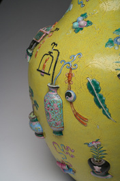 An exceptional pair of Chinese famille rose yellow sgraffito-ground bottle vases with applied design of antiquities, 19th C.