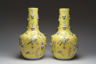 An exceptional pair of Chinese famille rose yellow sgraffito-ground bottle vases with applied design of antiquities, 19th C.