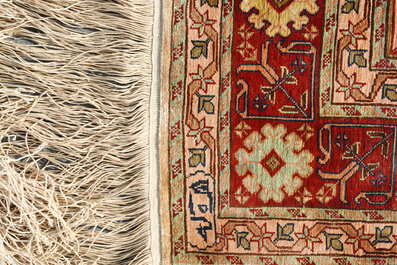 Two Turkish Hereke silk rugs with animals and floral design, 20th C.