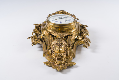 A French gilt bronze Louis XVI style cartel clock with a mascaron and floral design, Collin &agrave; Paris, 19th C.