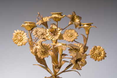 A French gilt bronze three-piece clock garniture with Erato, playful putti and S&egrave;vres style plaques, 19th C.
