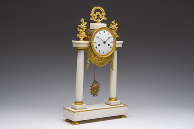 A French Neoclassical gilt bronze mounted white marble portico clock, 19th C.