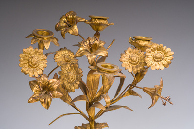A French gilt bronze three-piece clock garniture with Erato, playful putti and S&egrave;vres style plaques, 19th C.