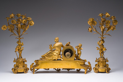A French gilt bronze three-piece clock garniture with Erato, playful putti and S&egrave;vres style plaques, 19th C.