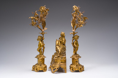 A French gilt bronze three-piece clock garniture with Erato, playful putti and S&egrave;vres style plaques, 19th C.