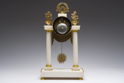 A French Neoclassical gilt bronze mounted white marble portico clock, 19th C.