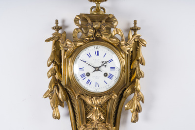 A French gilt bronze Louis XVI style cartel clock with a mascaron and floral design, Collin &agrave; Paris, 19th C.