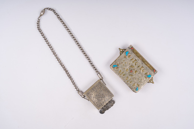 21 silver Tuareg pendants and two Koran boxes in silver and copper, Nigeria, Mali and Morocco, 19th/20th C.