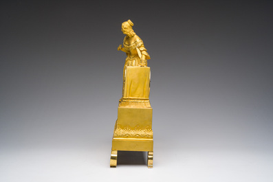 A fine French gilt bronze mantel clock crowned with a writing lady, 19th C.