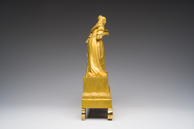 A fine French gilt bronze mantel clock crowned with a writing lady, 19th C.
