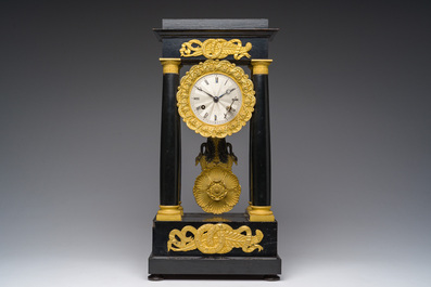 A French bronze mounted ebonized wooden column mantel clock, 19th C.