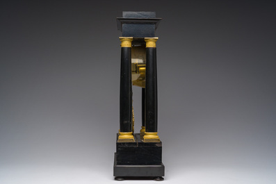 A French bronze mounted ebonized wooden column mantel clock, 19th C.