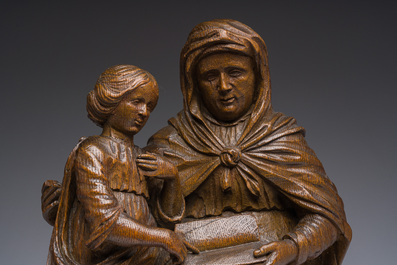 A Flemish oak group depicting Saint Anne teaching Mary to read, 19th C.