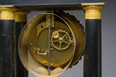 A French bronze mounted ebonized wooden column mantel clock, 19th C.