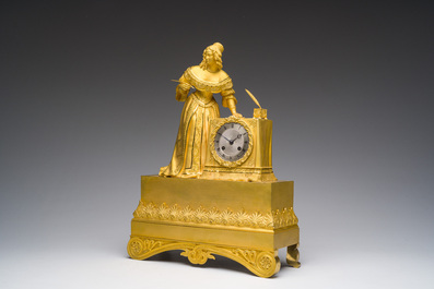 A fine French gilt bronze mantel clock crowned with a writing lady, 19th C.