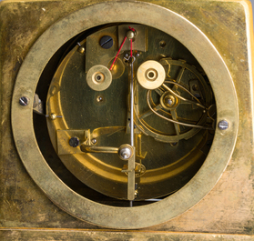A fine French gilt bronze mantel clock crowned with a writing lady, 19th C.