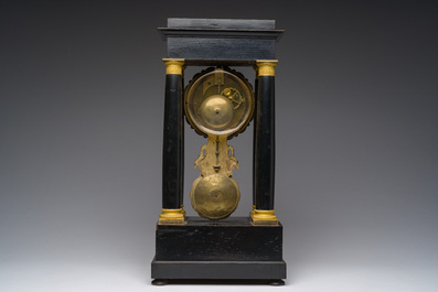 A French bronze mounted ebonized wooden column mantel clock, 19th C.