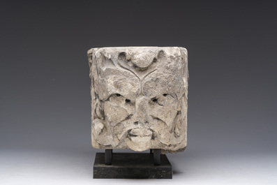 A Romanesque carved stone corbel with a grotesque head, probably France, 14th/15th C.