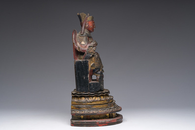 A Chinese gilt-lacquered wood sculpture of a dignitary, 19th C.