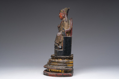 A Chinese gilt-lacquered wood sculpture of a dignitary, 19th C.