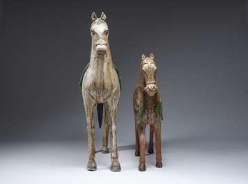 Two Indian polychrome decorated and patinated wooden horses, 20th C.