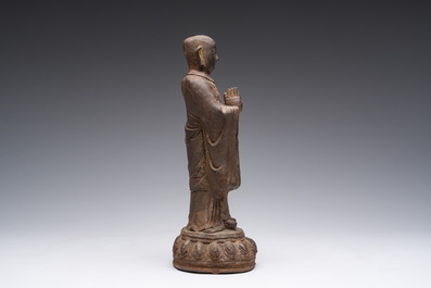 A Chinese cast iron sculpture of a Luohan, probably Ming