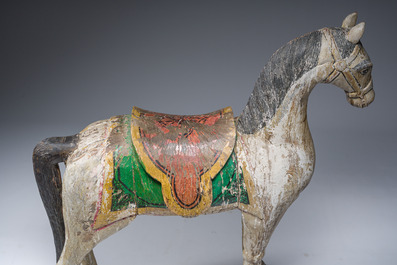 Two Indian polychrome decorated and patinated wooden horses, 20th C.