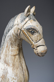 Two Indian polychrome decorated and patinated wooden horses, 20th C.