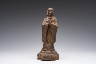 A Chinese cast iron sculpture of a Luohan, probably Ming
