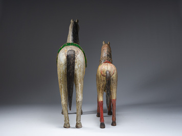 Two Indian polychrome decorated and patinated wooden horses, 20th C.