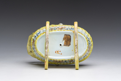 A polychrome Dutch Delft model of a cradle with child, 19th C.