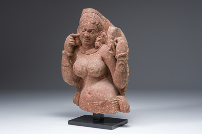 An Indian yellow-speckled red sandstone relief of a devata, probably Mathura school, Kushan period 2nd C. b.C./2nd C.